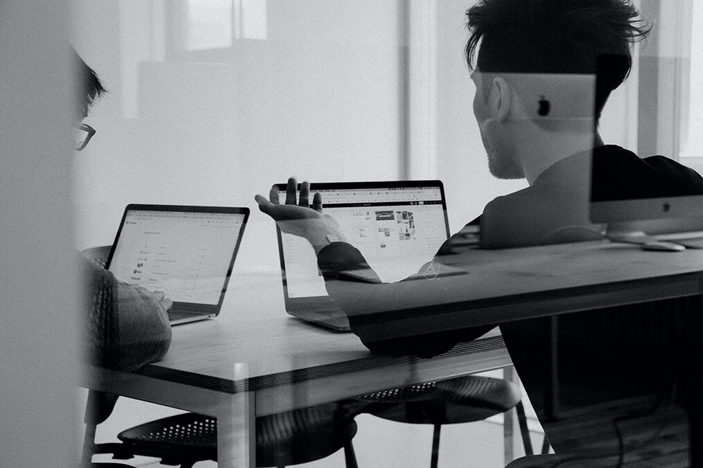Photo via Unsplash Two people working at their computers