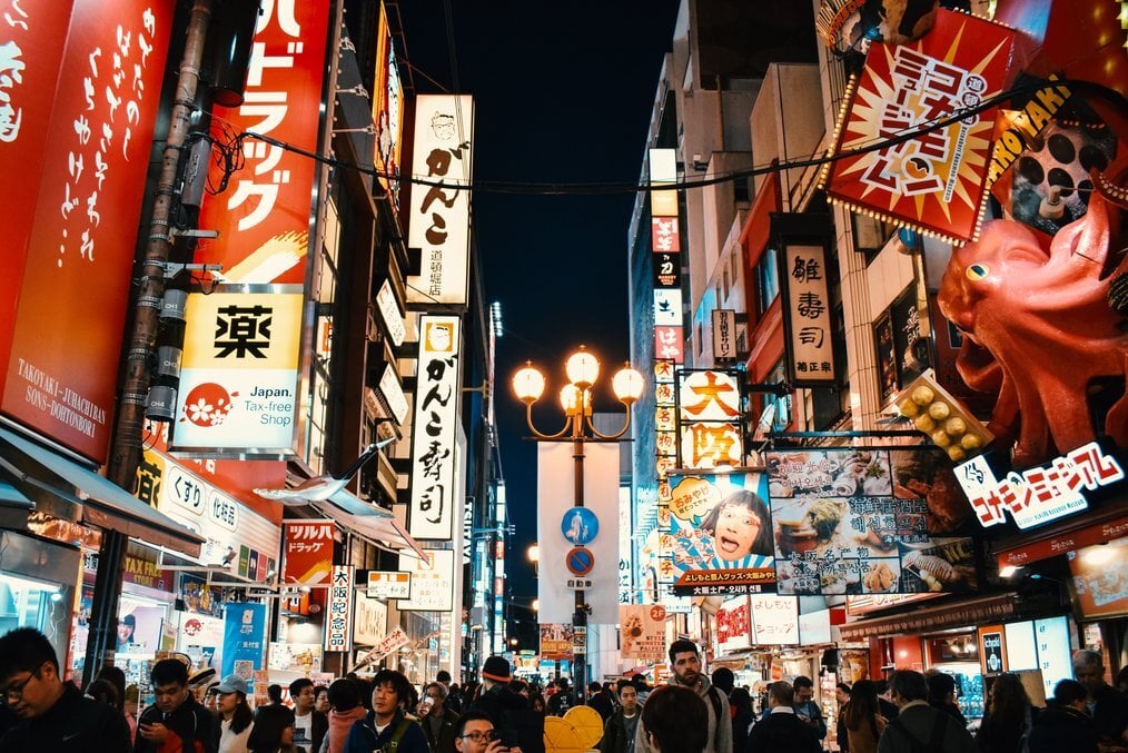 TB A busy street with many bright signs in Japanese.