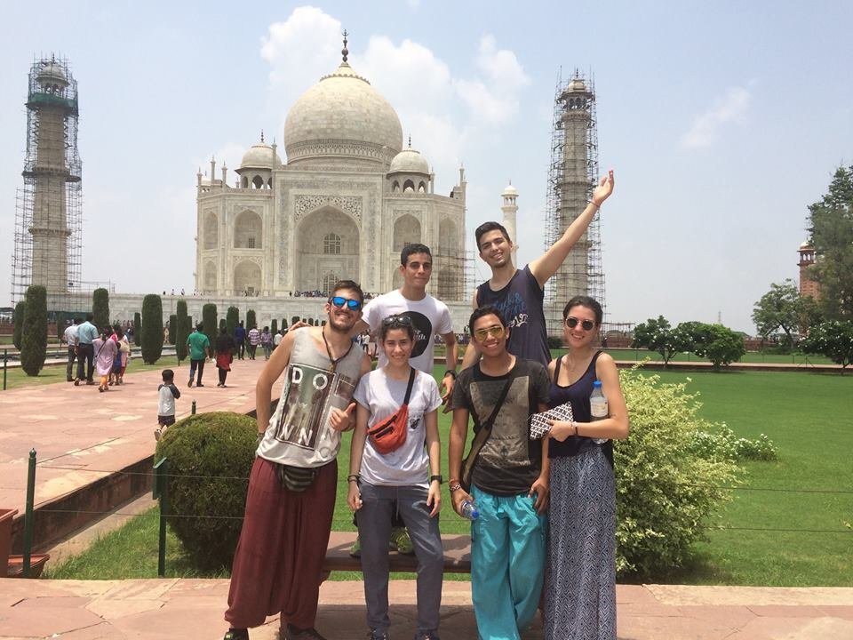 VolSol A group of people pose in front of the Taj Mahal in India.