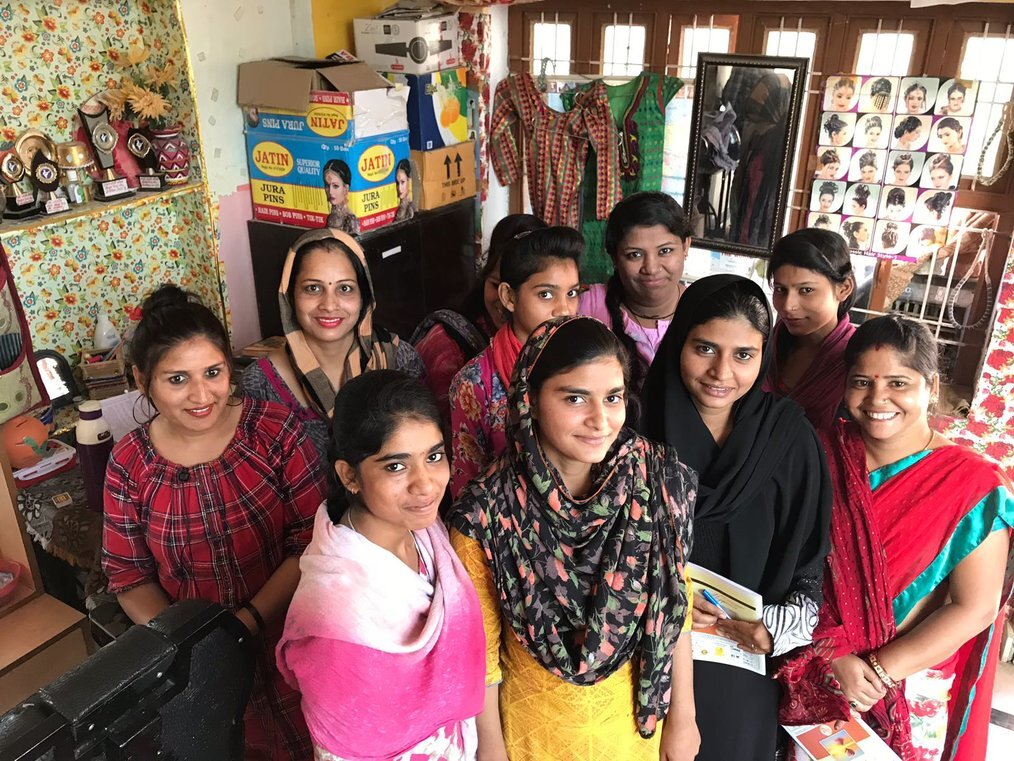 Women Empowerment Program India A group of women stand and smile.