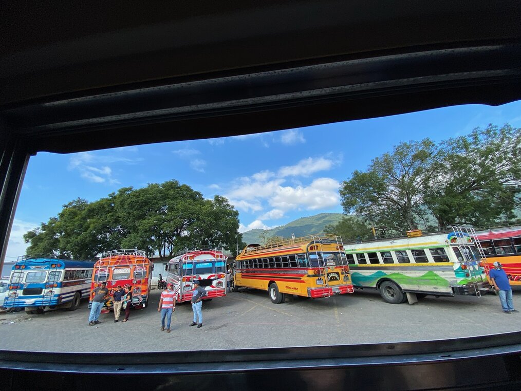 Row of colorful buses parked next to eachother