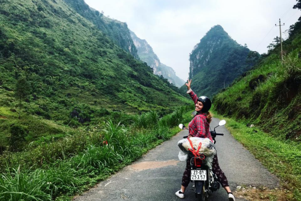 Traveler riding a bike through lush hills 