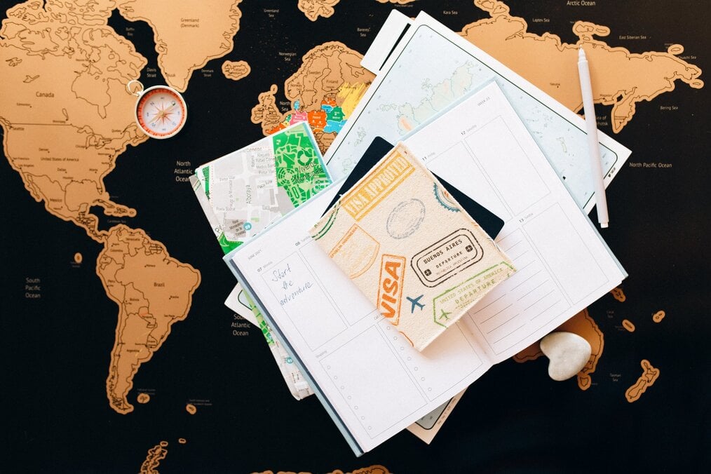 Passport and planner, laying on a map