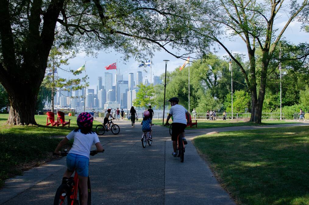 Children riding bikes in a city.