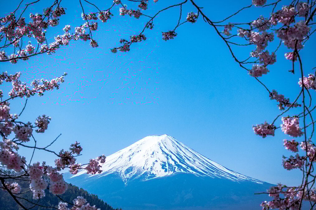 Photo via Unsplash A photo of Mt. Fuji with a blue sky behind