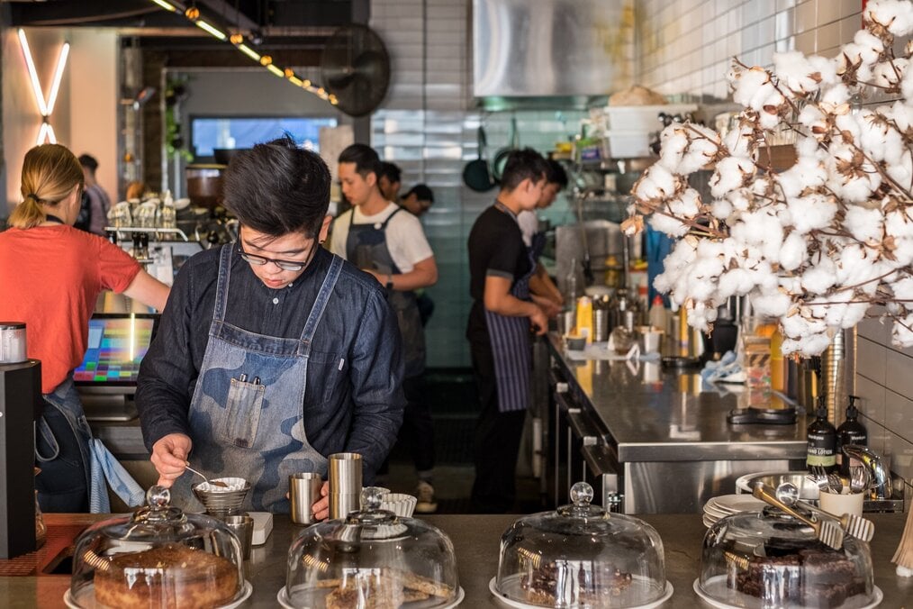 A barista nakes a coffee in a cafe in Australia.
