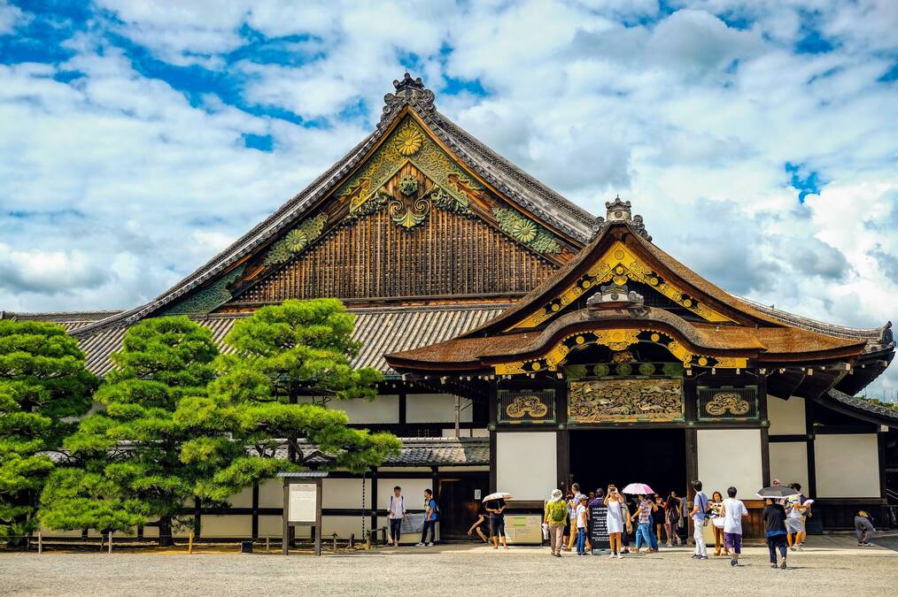 People stand outside of Nijo-jo Castle in Japan.