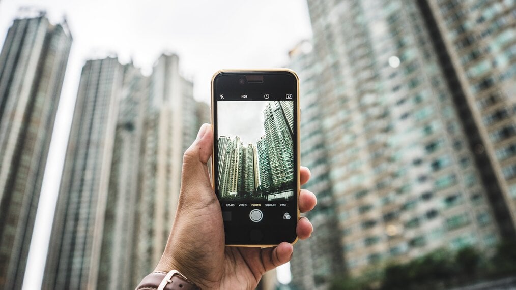 Photo by Redd F on Unsplash A hand holding up a cell phone taking a photo.