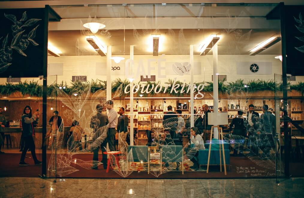 People socialize inside a building for coworking.