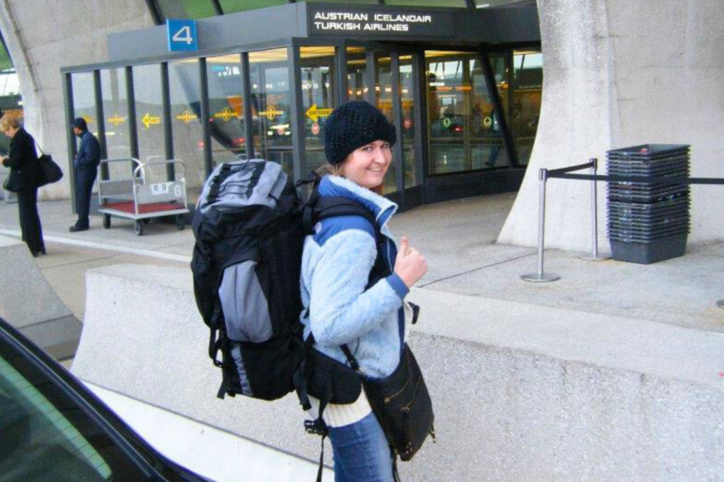 Andrea wearing a giant backpack and giving a thumbs up.