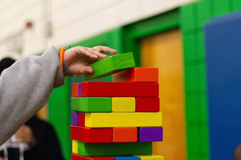 Child's hand playing with blocks