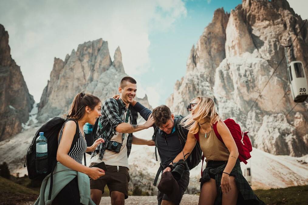 Friends laughing atop mountains 