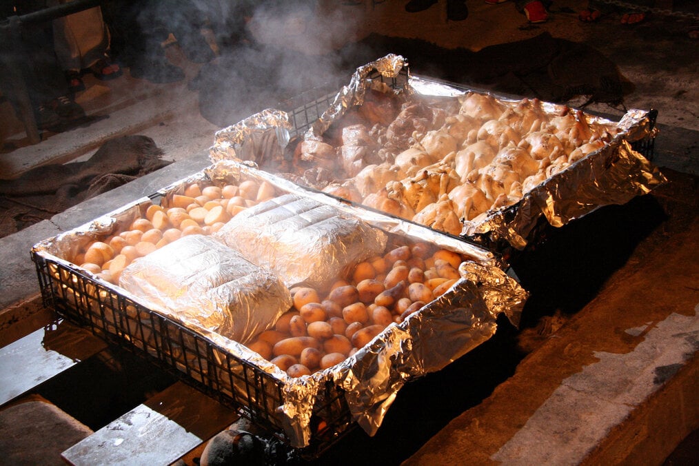 Hangi NZ Hangi food being prepared underground.