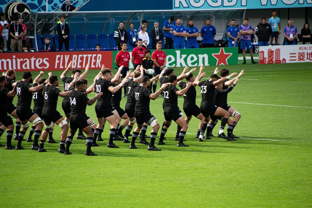 Photo by Stefan Lehner on Unsplash All Blacks rugby team doing pre-match haka.