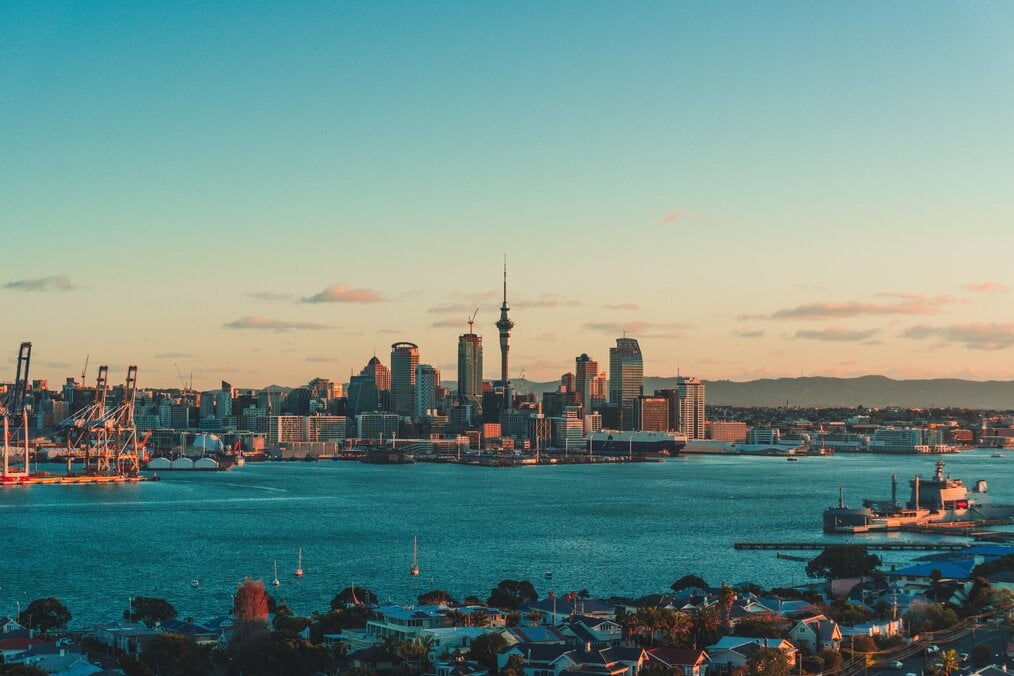 Photo by Sulthan Auliya on Unsplash Auckland at sunset by the water.
