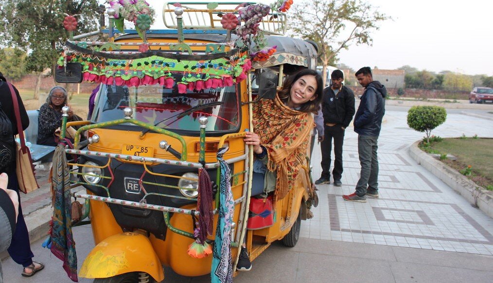 IUM Global India A woman sits in a colorful taxi in India.