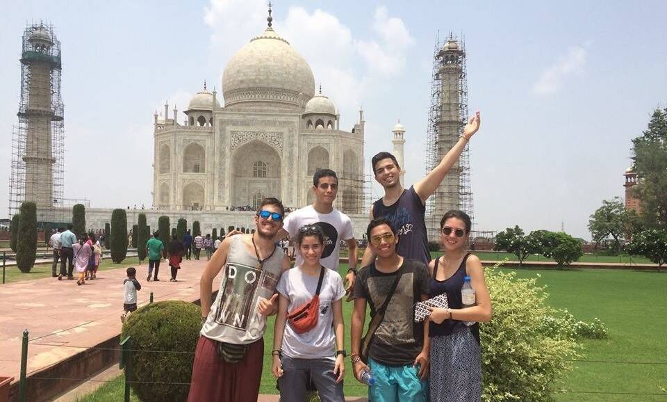 A group stands in front of the Taj Mahal.