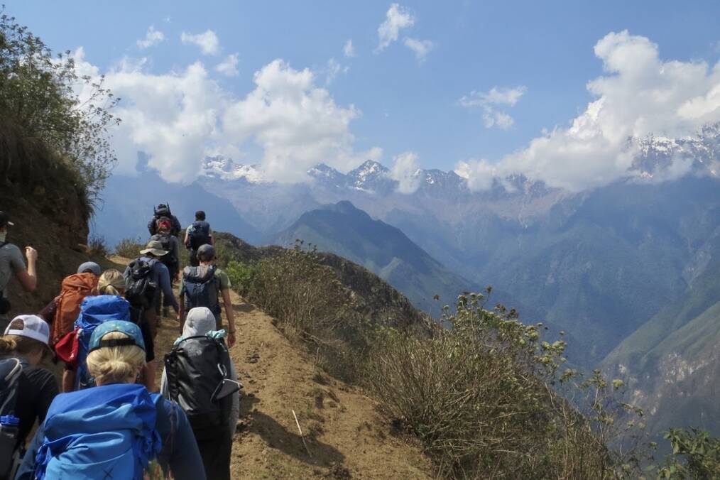 A group of travelers hiking through mountains