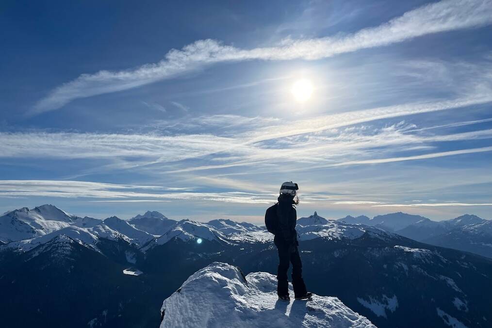 An independent traveler atop a mountain