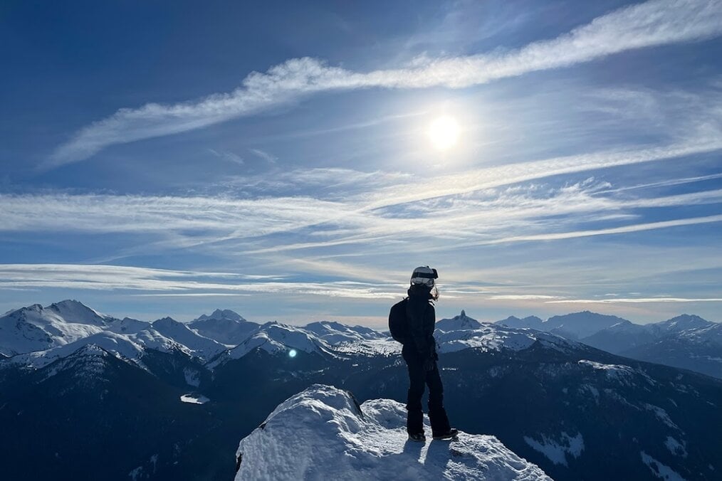 An independent traveler atop a mountain An independent traveler atop a mountain