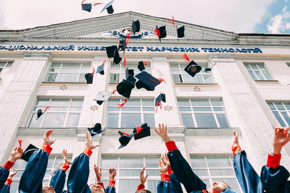 Photo by Vasily Koloda on Unsplash Students throw caps in the air at graduation.