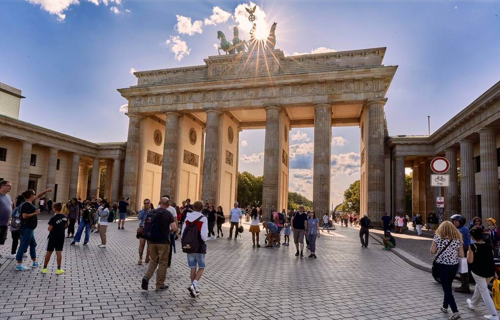 People walk near the Brandenburg Gate in Berlin.
