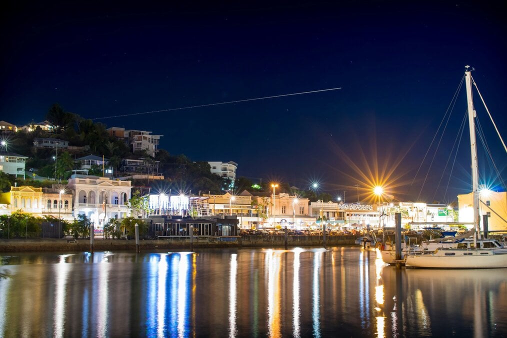 A view of the harbor in Townsville, Australia at night.