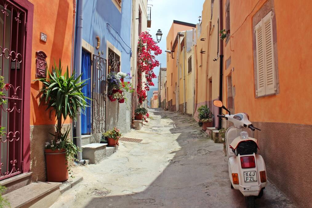 A moped in a narrow street in Italy