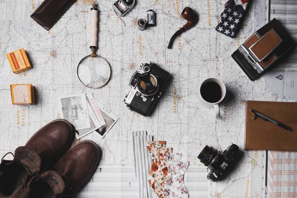 A camera, magnifying glass, and other items on a map