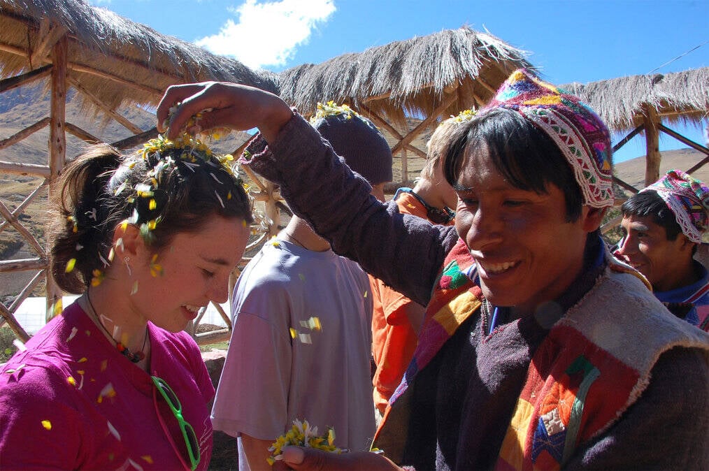 A man sprinkles confetti on a smiling girl's head.
