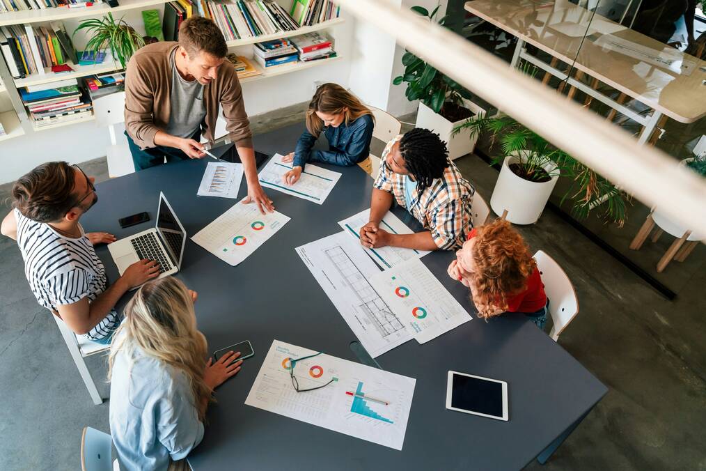People sit around a table and look at graphs.