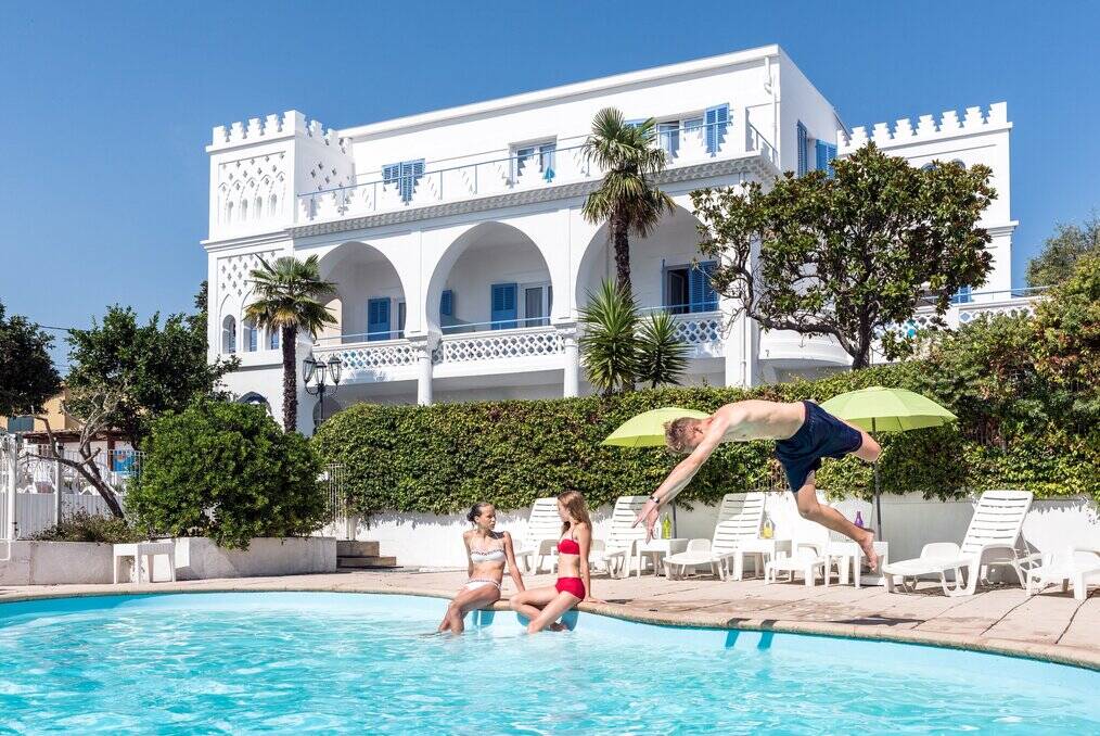 Teens sit by a pool in France.
