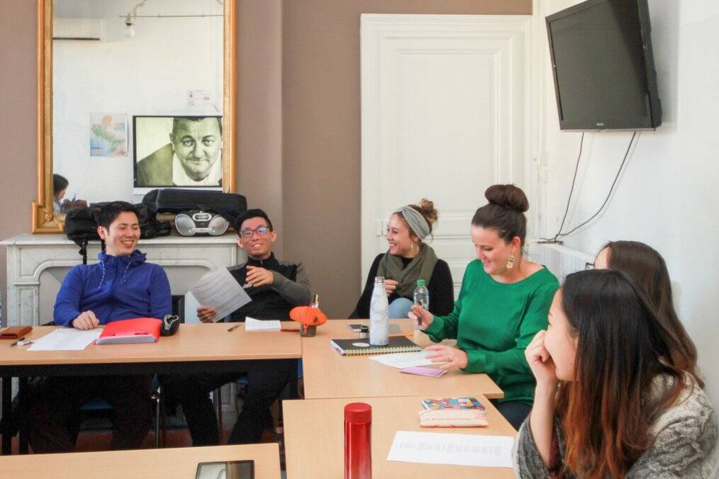 Students sit around in a classroom.