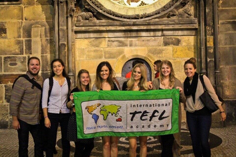 A group of ITA students hold a banner.