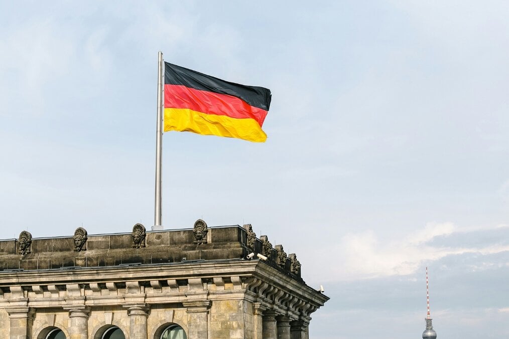 Best cities in Germany A German flag on top of a tall building