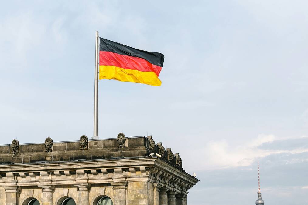 A German flag on top of a tall building