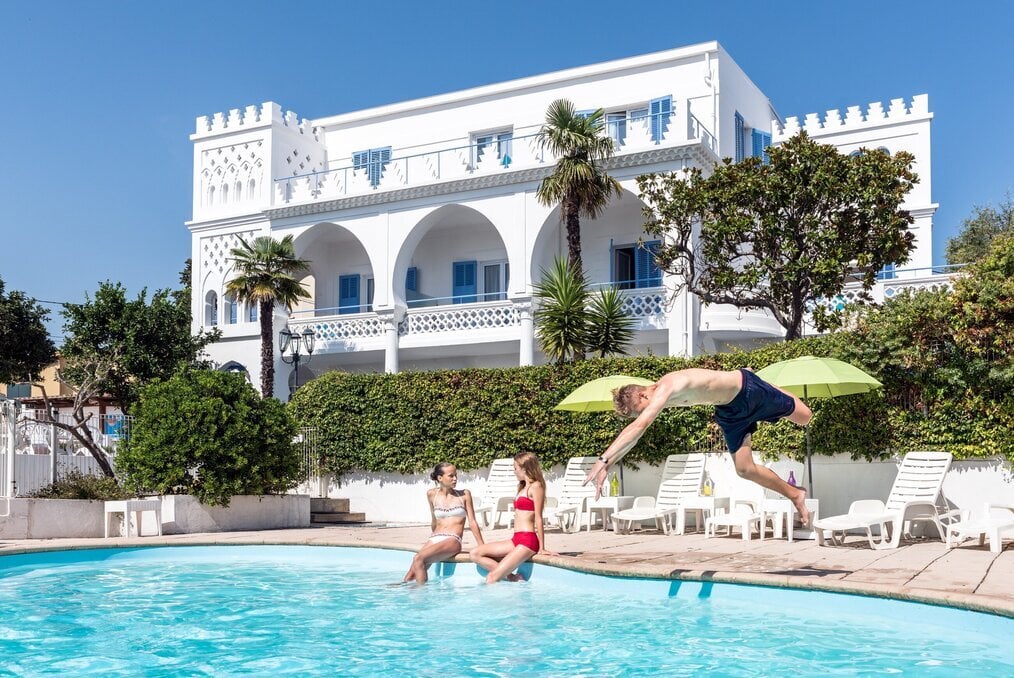 NACEL A boy dives into a pool.