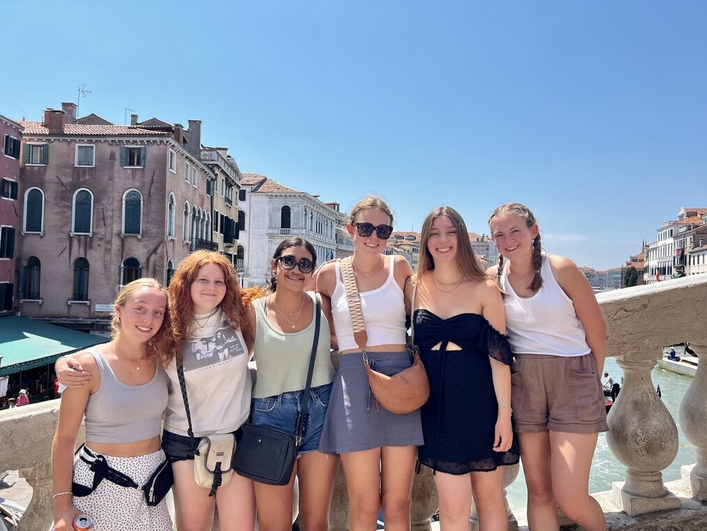 AR A group of teen girls pose for a picture in Italy.