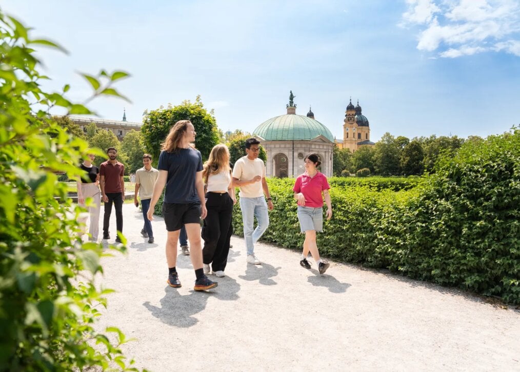 EF A guide walks with people through a garden.