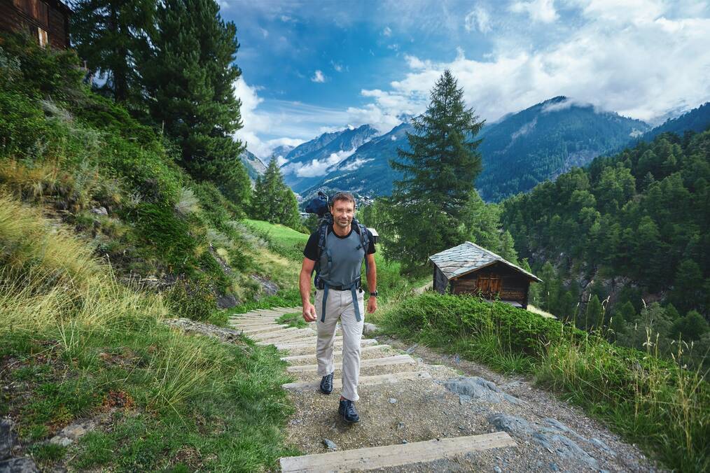 A man hikes in the mountains in Italy.
