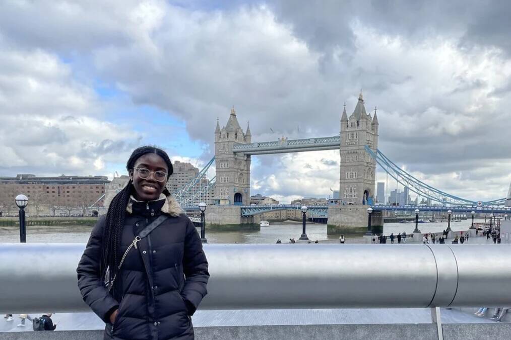 A person standing in front of the tower bridge in London