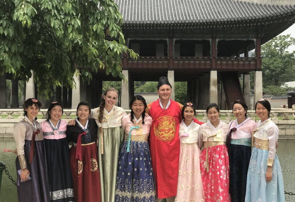 People pose for a photo in traditional Korean dress.
