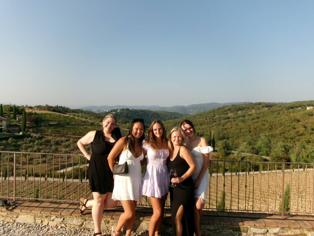 Students smiling in front of a vineyard in Rome