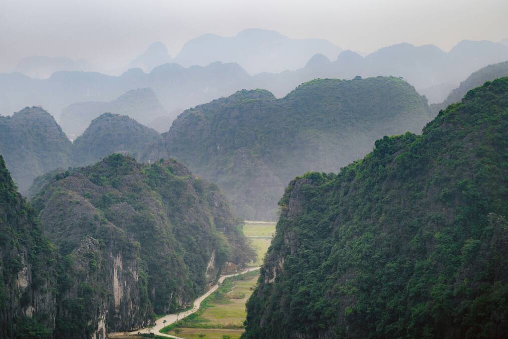 A view of a valley with mountains in the background