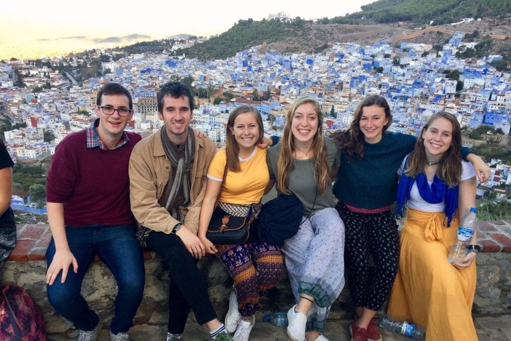 Hayley S., IES Abroad Granada Alum A group of people sat down with a backdrop of a Spanish city