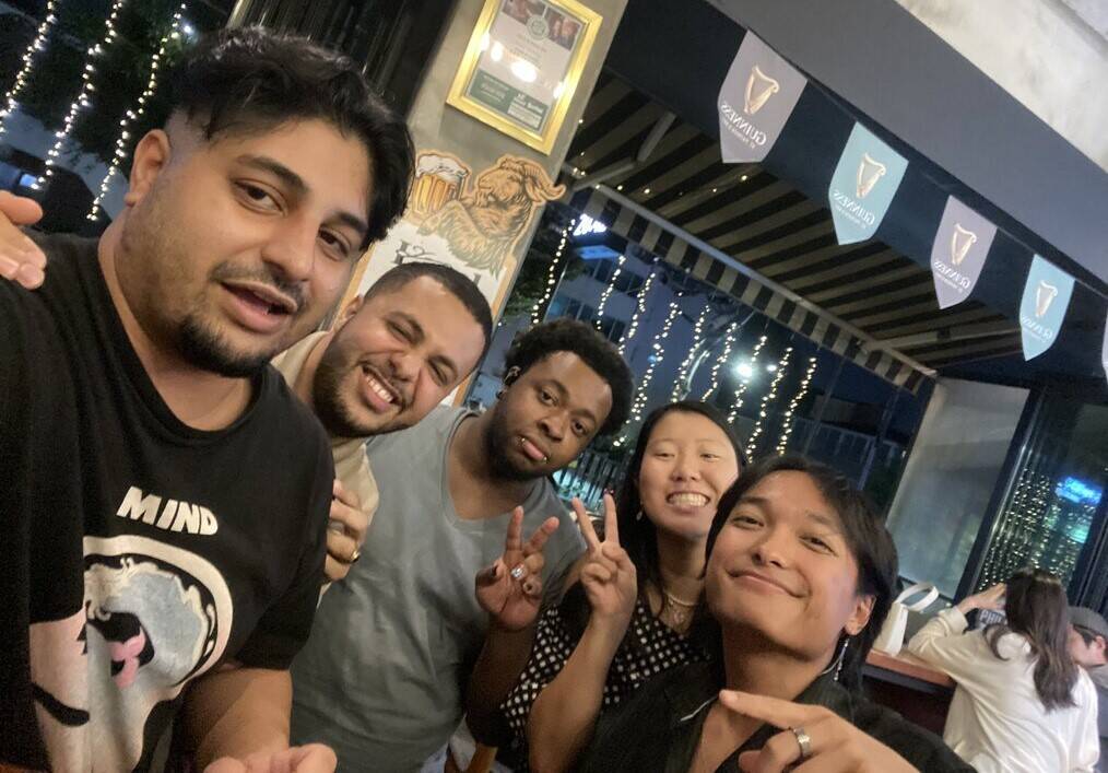 A group of friends pose for a selfie.