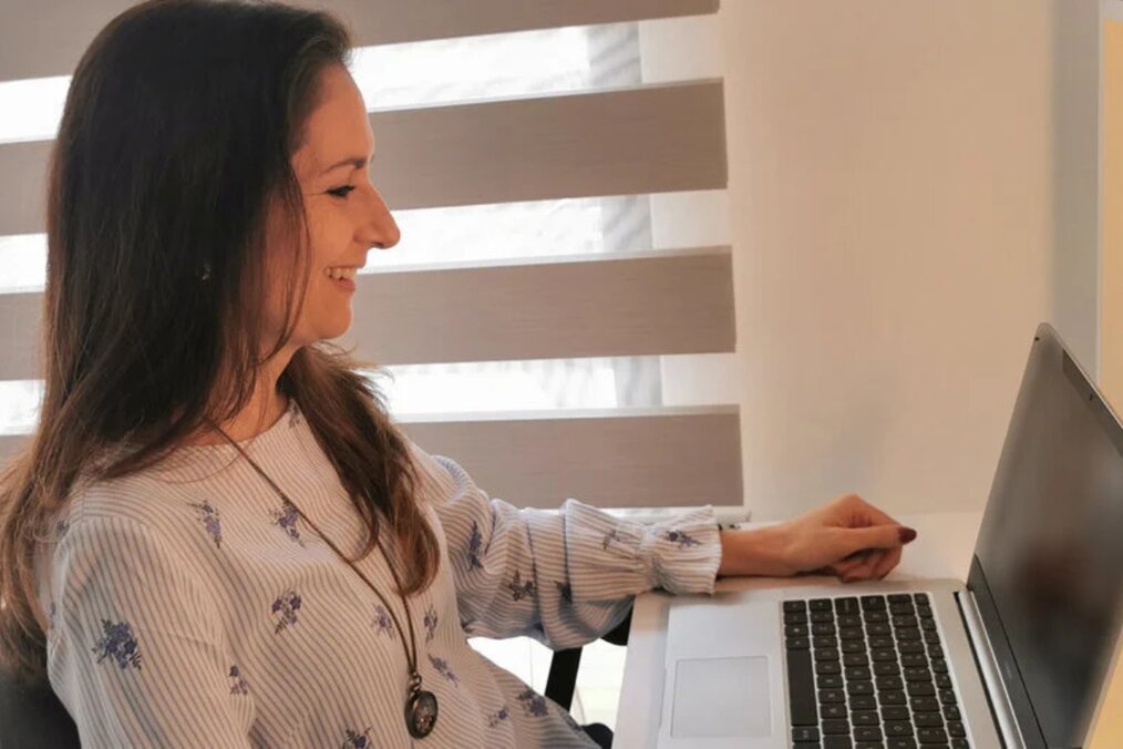 OnTESOL A person using the laptop smiling