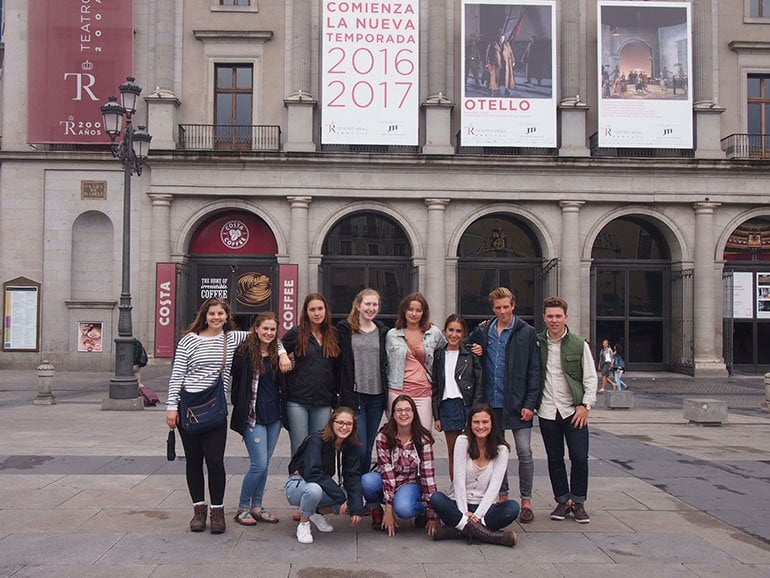 Exchange A group of teens pose in front of a museum in Spain.