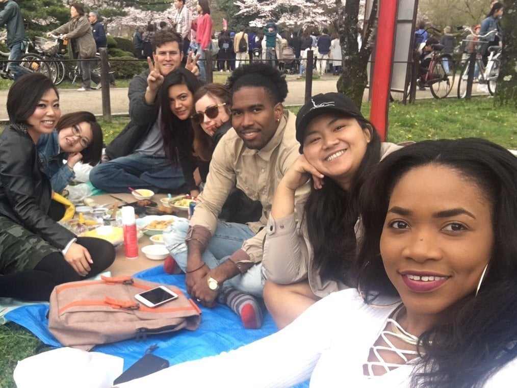 Japan teachers A group of people have a picnic outside.