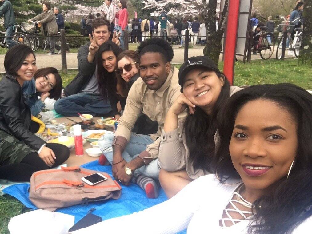 A group of people have a picnic outside.